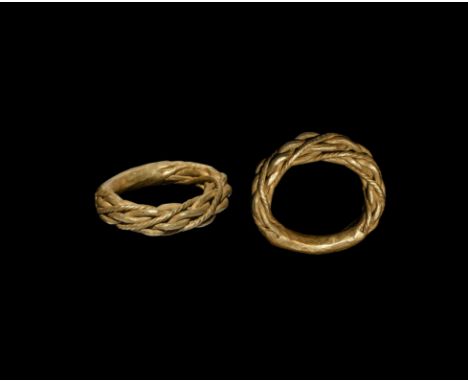 9th-11th century AD. A substantial gold ring formed from plaited rods with three decorative twisted rods, the underside hamme