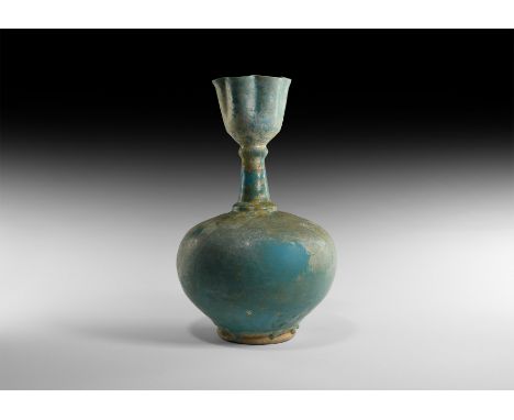 12th-13th century AD. A turquoise-coloured ceramic bottle with bulbous body, tapering neck with collars and tulip-shaped mout