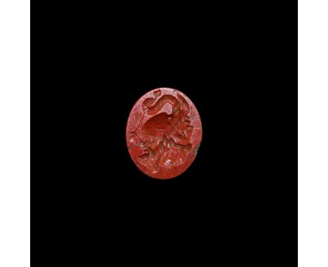 1st-2nd century AD. A red jasper plaque with intaglio gryllus motif of three profile faces and a serpent's tail.   0.82 grams