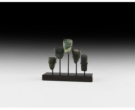 Neolithic, 6th-3rd millennium BC. A group of five polished diorite miniature axeheads; mounted on a custom-made stand.   299 