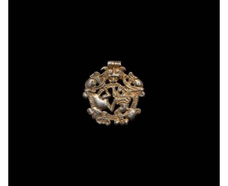 10th-11th century AD. A silver-gilt pendant with Borre-style beast and integral suspension loop with herringbone detailing; t