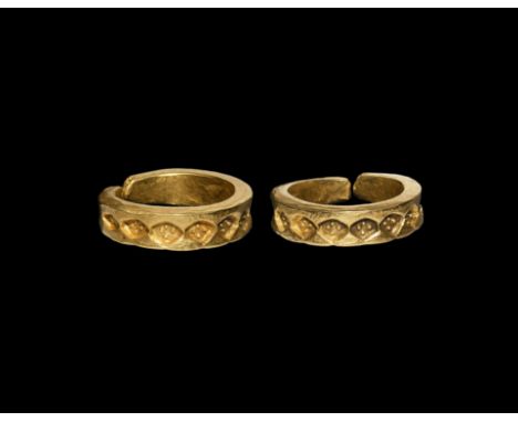 9th-10th century AD. A substantial finger ring formed as a thick rectangular-section penannular band with pellet-in-lozenge s