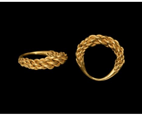 9th-10th century AD. A finger ring of braided gold wire tapering to the ends and fused to the underside.   11.2 grams, 28.26m