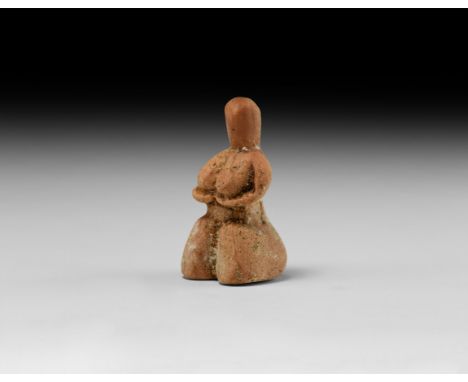 3rd-2nd millennium BC. A ceramic female figure with hands clasped beneath the breasts, pinched head, exaggerated hips.   26 g
