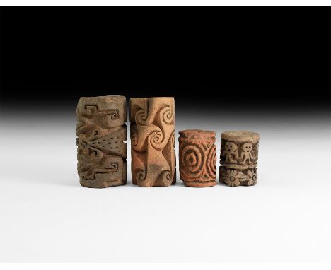 1st millennium AD. A group of four ceramic large cylinder seals comprising: one with frieze of figures holing hands over flow