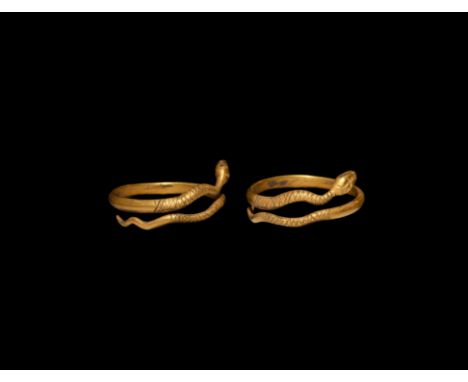 1st century BC. A gold penannular finger ring with overlapping ends formed as the head and tail of a snake, hatched texture t