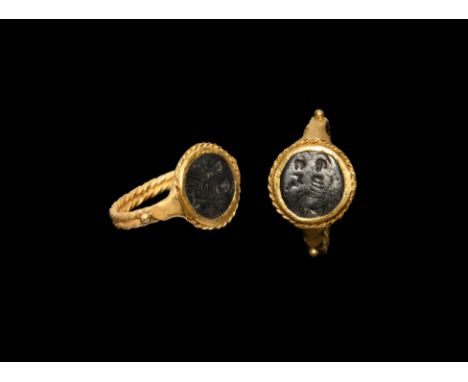 5th-6th century AD. A gold finger ring with two-ply twisted wire hoop, granule and triangular panel to each shoulder, twisted