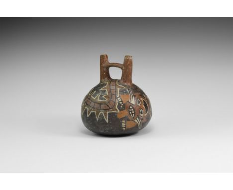 1st millennium AD. A ceramic stirrup jar with domed underside, two conjoined spouts, painted motif of an S-shaped reptile wit