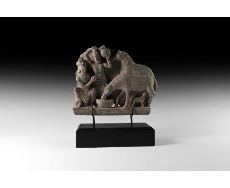 3rd-4th century AD. A carved schist frieze fragment with a mare drinking from a bowl and suckling her foal, second horse to t
