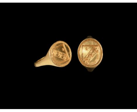 16th-17th century AD. A gold signet ring comprising a slender hoop and ellipsoid bezel with heater shield in a beaded border 