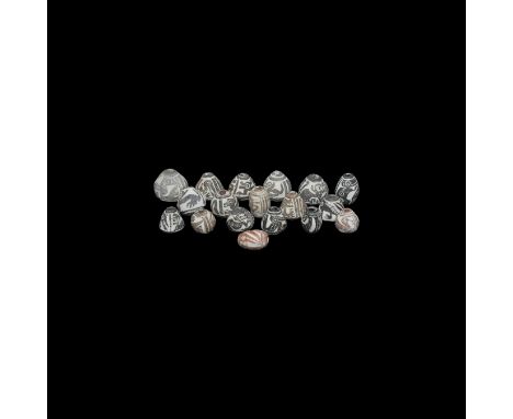 8th-15th century AD. A group of ceramic conical, barrel-shaped and other manteno beads with traditional impressed designs. 48