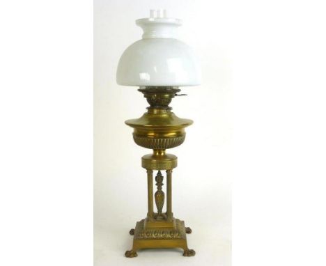 A Victorian oil lamp, the glass shade on a brass support of Neo-Classical form on claw feet, h. 63 cm
 CONDITION REPORT: Poss