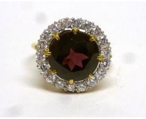 An 18ct yellow gold cluster ring set red coloured glass in a surround of brilliant cut diamonds, ring size Q, 7.3 gms