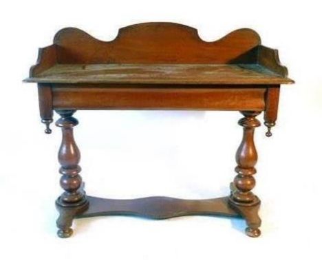 A Victorian mahogany washstand, the shaped gallery above a moulded top on turned end supports joined by a shaped board stretc