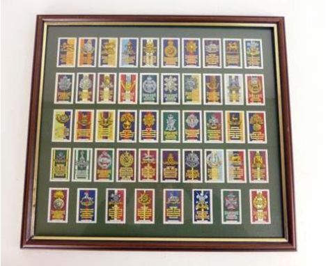 A presentation case of fifty Gallaher Limited army badges and cigarette cards including Royal Sussex, Welsh Regiment, Black W