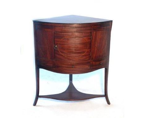 A late Georgian bow fronted mahogany and line inlaid corner enclosed basin stand, the lift up top enclosing circular hole to 