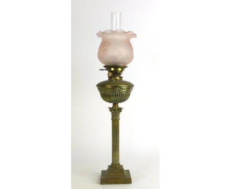 A Victorian oil lamp, the pink glass shade on a brass Corinthian column by Maple Hinks of London, h. 78 cm
