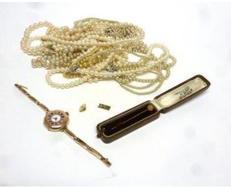 A part 9ct yellow gold ladies wristwatch, a yellow metal stick pin set small rose cut diamond and a selection of artificial p