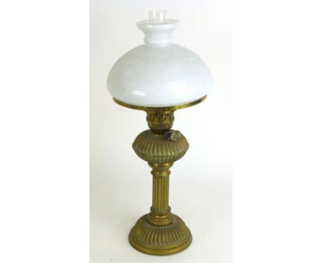 A Victorian oil lamp the white glass shade over a brass support of reeded form h. 63 cm
