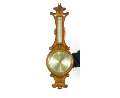 An early 20th century oak banjo barometer, the Art Nouveau case incorporating thermometer and circular weather dial, made by 