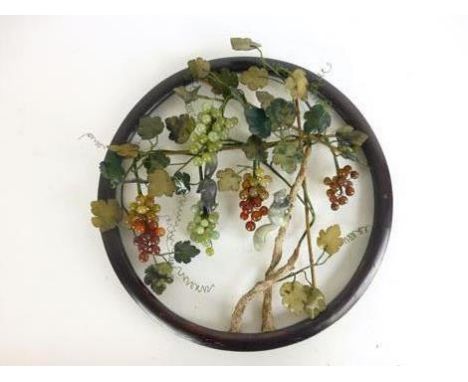 A hardstone and jade wall display depicting squirrels on branches with fruits, in a circular hardwood frame, d. 40 cm  