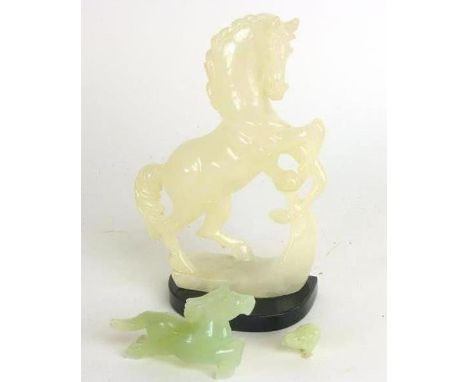 A Chinese jade figure modelled as a horse, l. 10 cm, together with a miniature figure of a hen and a jade-type ornament model