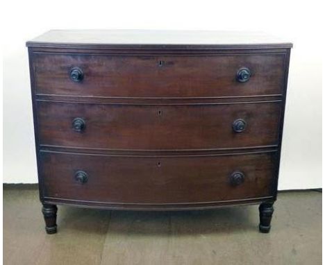 A 19th century mahogany bow fronted chest of drawers, the moulded top over three long graduated drawers with turned knobs on 