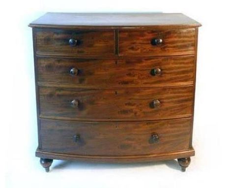 A Victorian mahogany bow front chest of drawers, with two over three graduated drawers, the cock beaded drawers having turned