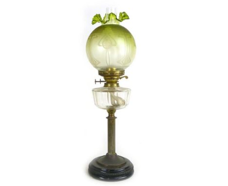 A Victorian oil lamp, the spherical green glass shade decorated with Art Nouveau-type motifs over a clear reservoir on Corint