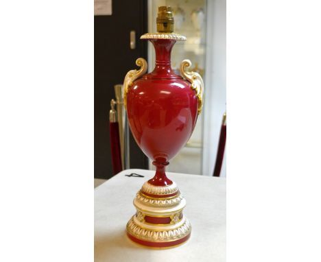 A Royal Worcester ruby ovoid  lamp, flying leafy scroll handles, the base with leaves and flutes, picked out in gilt, 39.5cm 