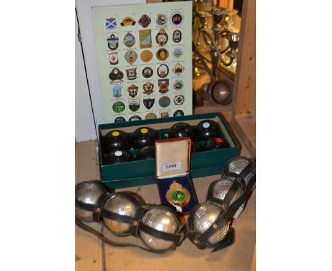 A set of B and A indoor carpet bowls, boxed; a set of six boles; bowling club membership badges