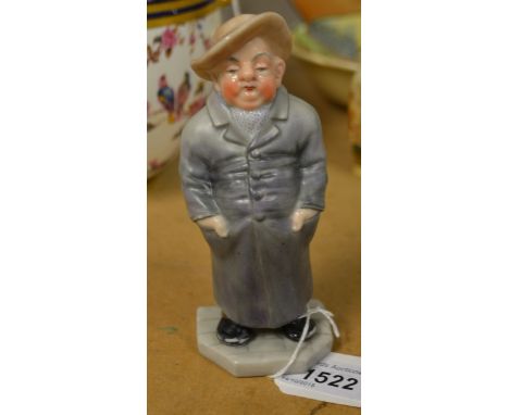 A  Royal Worcester figure,  from the 'Down and Out' series, standing, with hands in his pockets, wearing a broad brimmed hat 