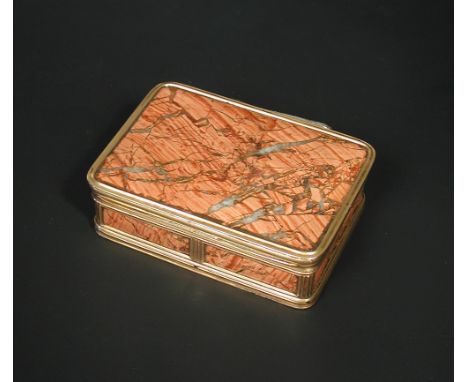 An early 19th century gold mounted red agate pocket snuff box, unmarked, of rectangular shape with reeded edges, 77 x 27 x 55