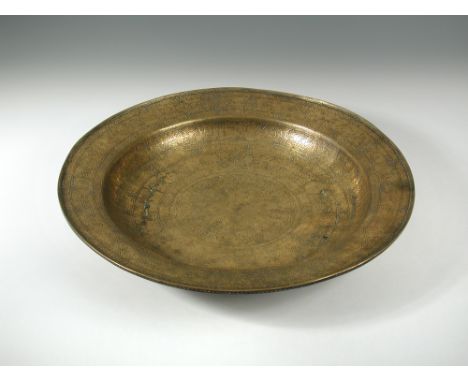 A large Veneto-Saracenic brass salver or charger, possibly Venetian 16th century, with wide sloping rim and rounded lip, roun