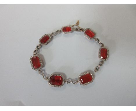 An early 20th century fire opal and diamond bracelet, designed as a line of graduated emerald cut burnt orange colour fire op