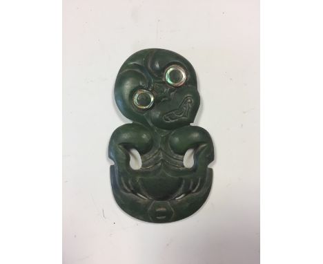 A Maori carved nephrite jade Hei Tiki, inset with mother-of-pearl eyes 8cm (3in)  