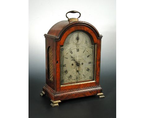 A George III mahogany bracket clock, the break-arch case with folding handle, 8inch arched silvered engraved one-piece dial s