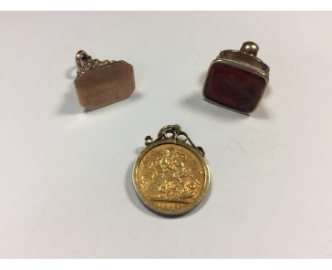 Edward VII gold sovereign, 1903 in a 9ct gold pendant mount, a 9ct gold fob seal and a gold plated seal the cornelian seal wi