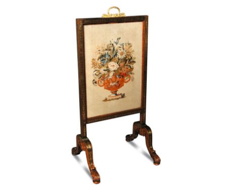 A Regency rosewood and brass inlaid firescreen, with a chased gilt ormolu handle and trailing husk inlays, on leaf carved scr