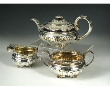 A George IV silver three piece teaset, by William Troby, London 1821/1822, comprising:- a teapot of compressed circular shape