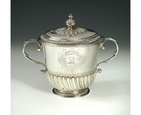 A William III silver cup and cover, maker C.C, London 1699, of tapering cylindrical form, the lower body wrythen fluted above