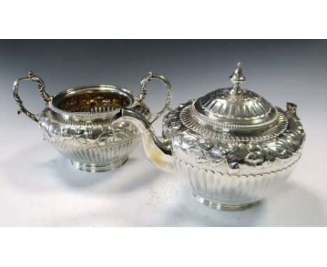 A Victorian silver teapot, by Robert Sibley II, London 1860, circular, the lower body fluted below a floral embossed and flut