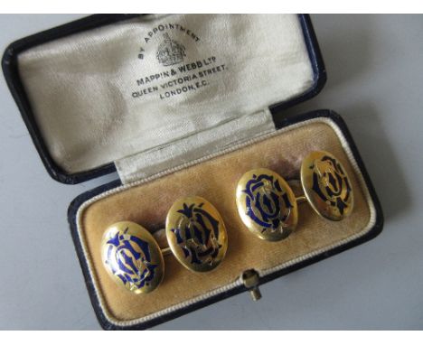 A pair of late Victorian double-ended enamelled monogram cufflinks, each end a convex oval plaque of yellow precious metal st