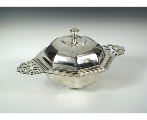 A silver muffin dish with cover and liner, by Carrington & Co, London 1913, of plain octagonal form with moulded edges and wi