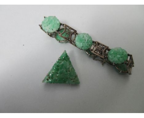 A carved jade bracelet together with a carved jade brooch, the bracelet composed of six circular pierced plaques carved to de