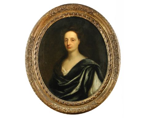 Circle of Michael Dahl (Swedish, 1659-1743) Portrait of a lady in a cream dress and blue cloak oil on canvas, oval 64 x 58cm 