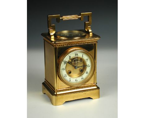 A 19th century French brass mantel timepiece, the rectangular case of carriage form with silvered compass and thermometer bel