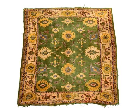 A Ushak green ground carpet, 370 x 312cm (144 x 122in)  