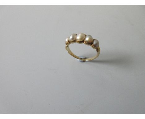 A five stone pearl ring, the graduated line of slightly oval pearls, untested but thought to be natural, in closed back crimp