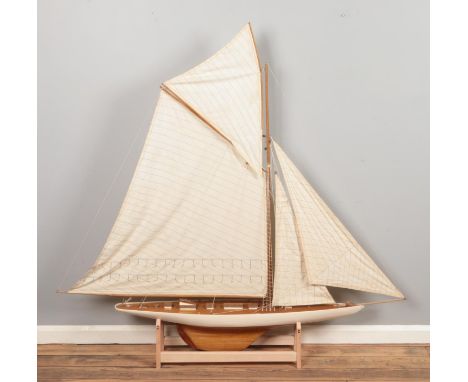 A very large multi-sail model of a yacht, with wooden decking and hull and custom built stand. Height: 163cm, Width: 170cm.  